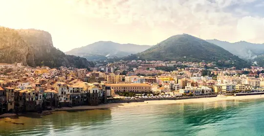 Italian coastline town with mountain backdrop